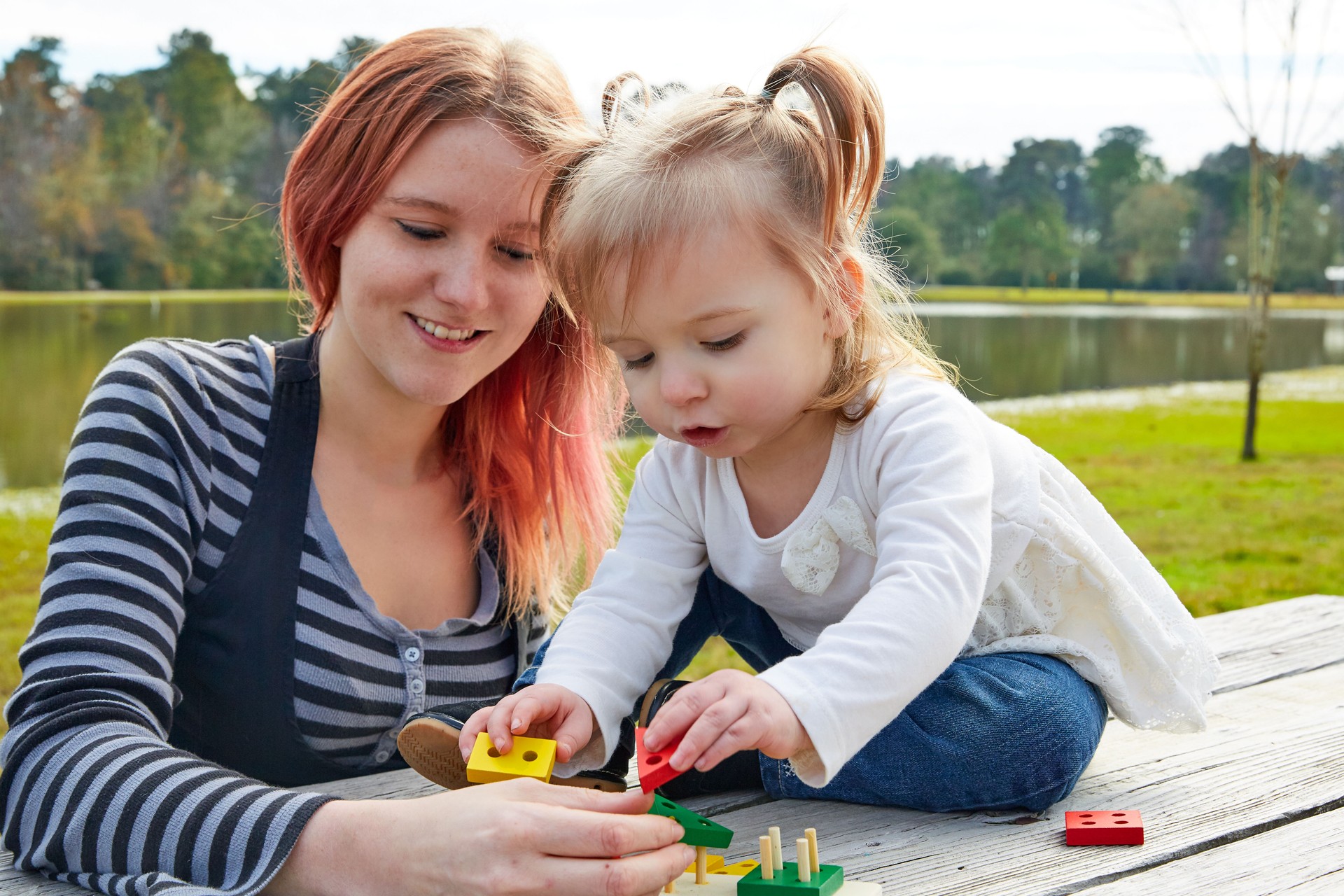 Mother and daughter playing with shapes in park