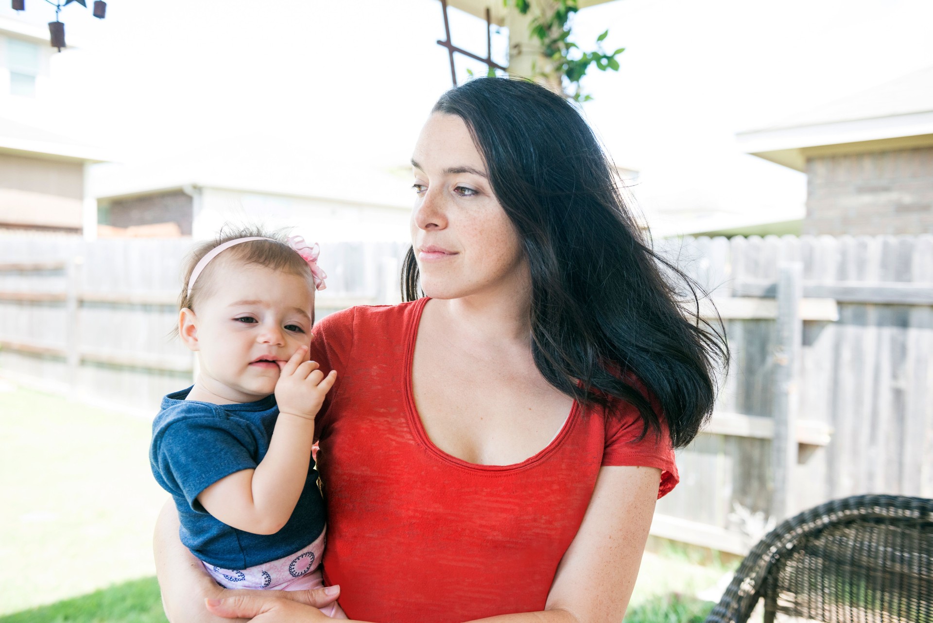Millennial Mother Holding Baby Girl Outside Home USA